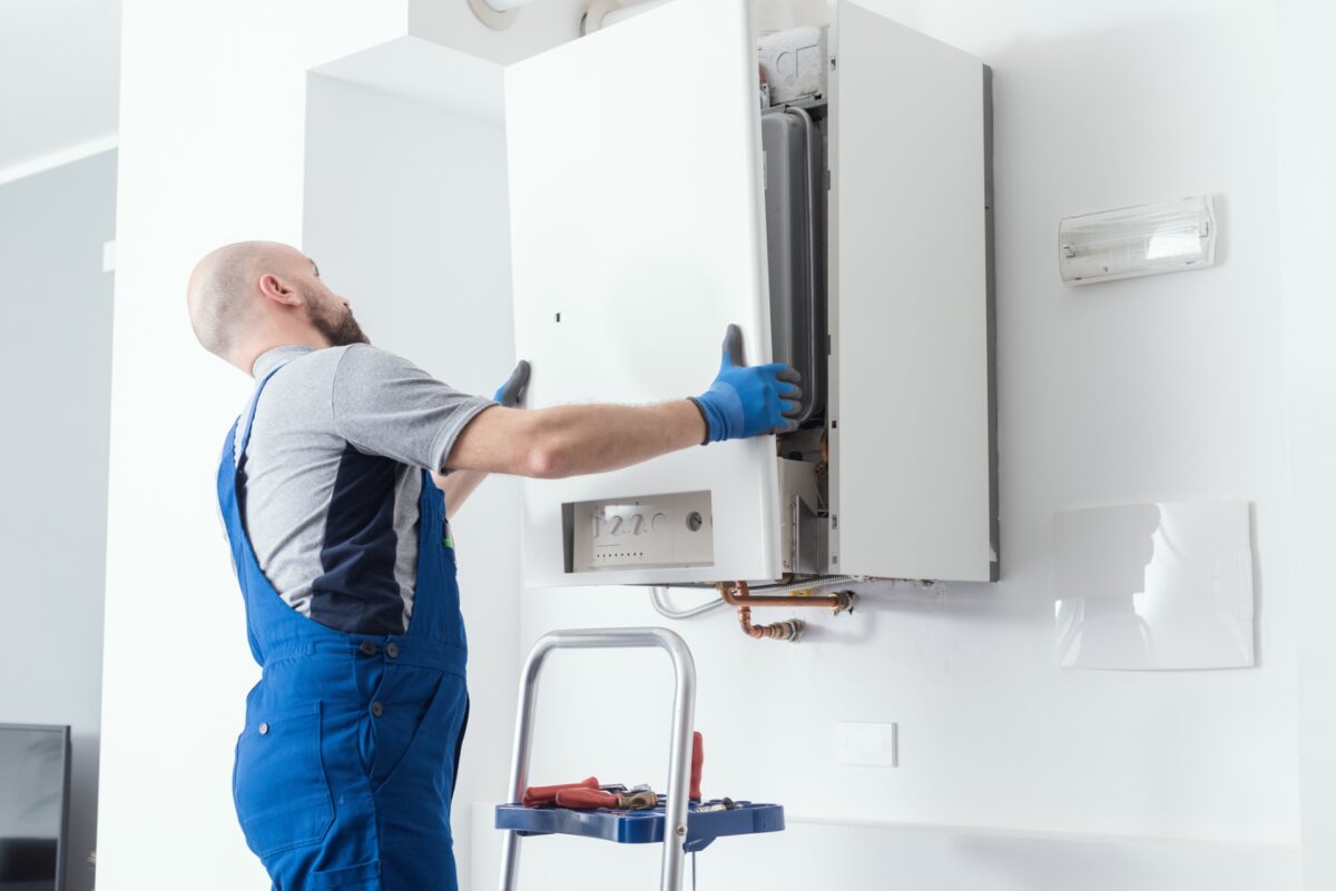 man fitting a boiler